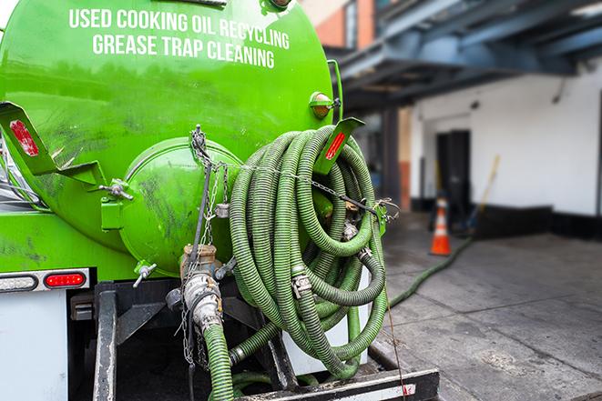 a plumber pumping a grease trap in Dunedin FL